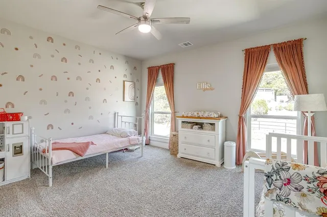 a bedroom with furniture and baby crib