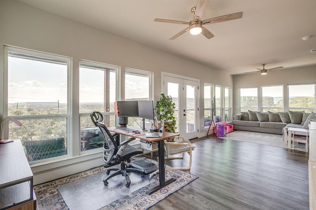 9720 Scenic View Court Rio Vista, TX 76093 - Photo 26 of 31 a dining room with wooden floor and a floor to ceiling window