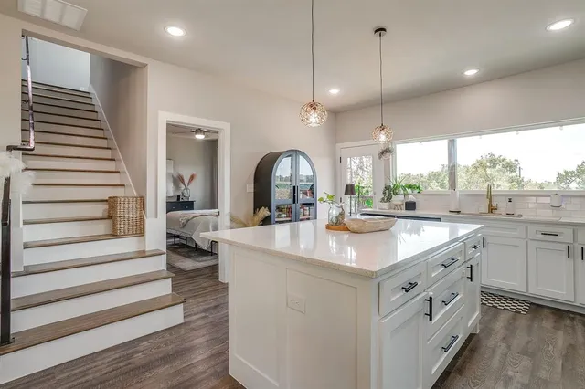 a large kitchen with kitchen island a large island in the center