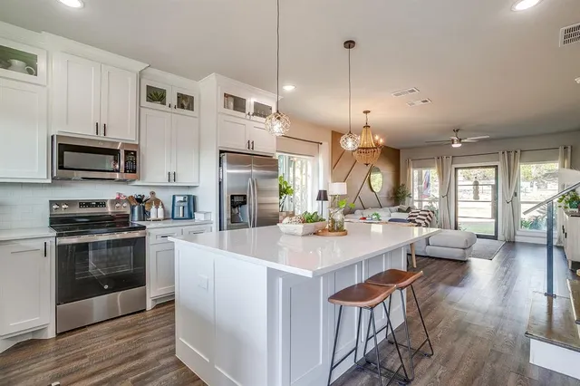 a kitchen with a sink a stove and a microwave
