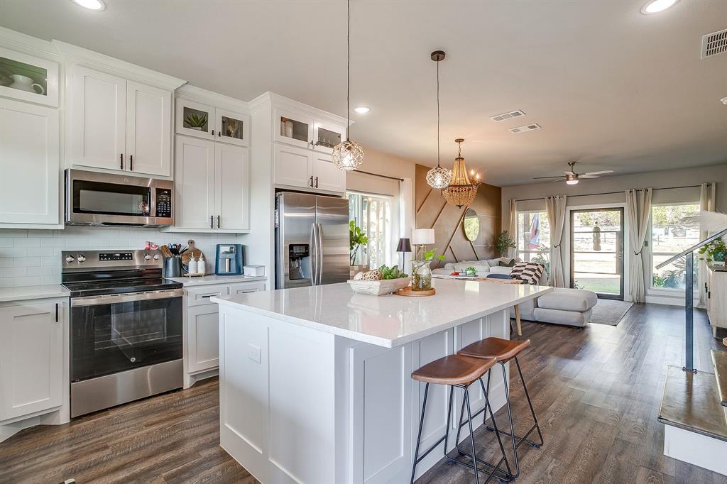 9720 Scenic View Court Rio Vista, TX 76093 - Photo 10 of 31 a large kitchen with kitchen island a large island in the center