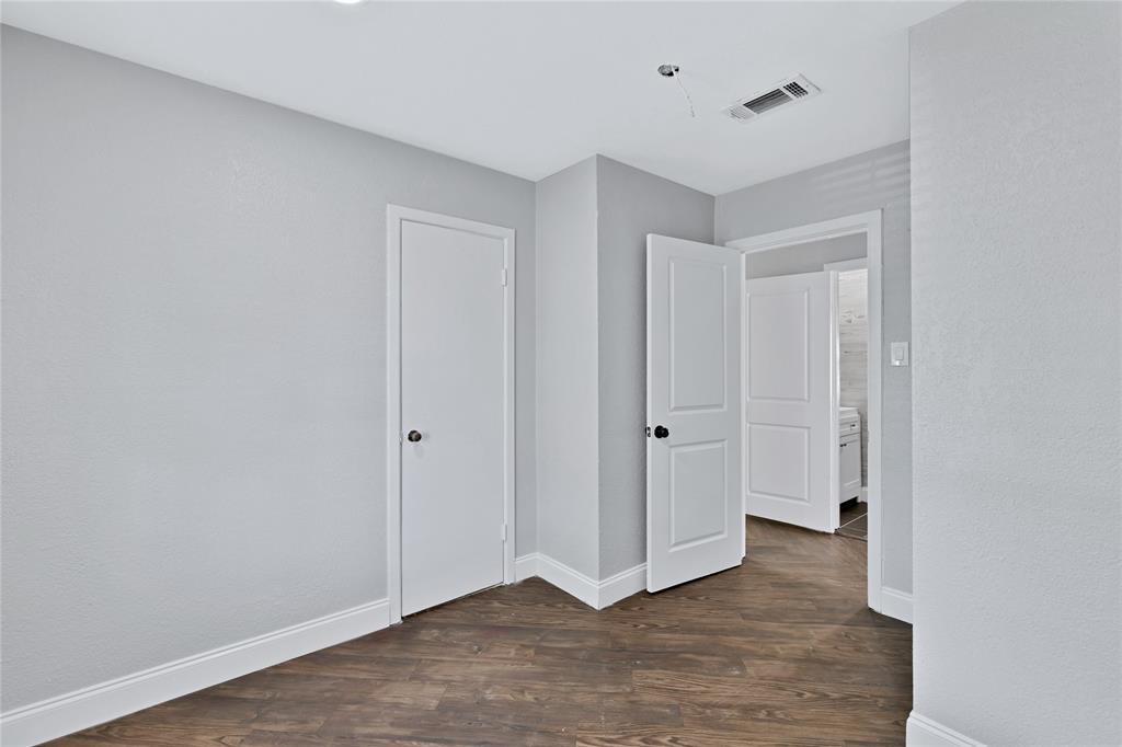 4120 Fry Street Fort Worth, TX 76115 - Photo 13 of 29 Unfurnished bedroom featuring dark wood-style floors and baseboards