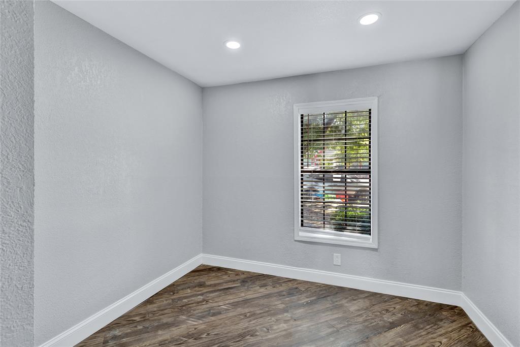 4120 Fry Street Fort Worth, TX 76115 - Photo 17 of 29 Empty room featuring a textured wall, dark wood-style floors, and recessed lighting