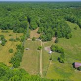 an aerial view of residential house with an outdoor space and seating