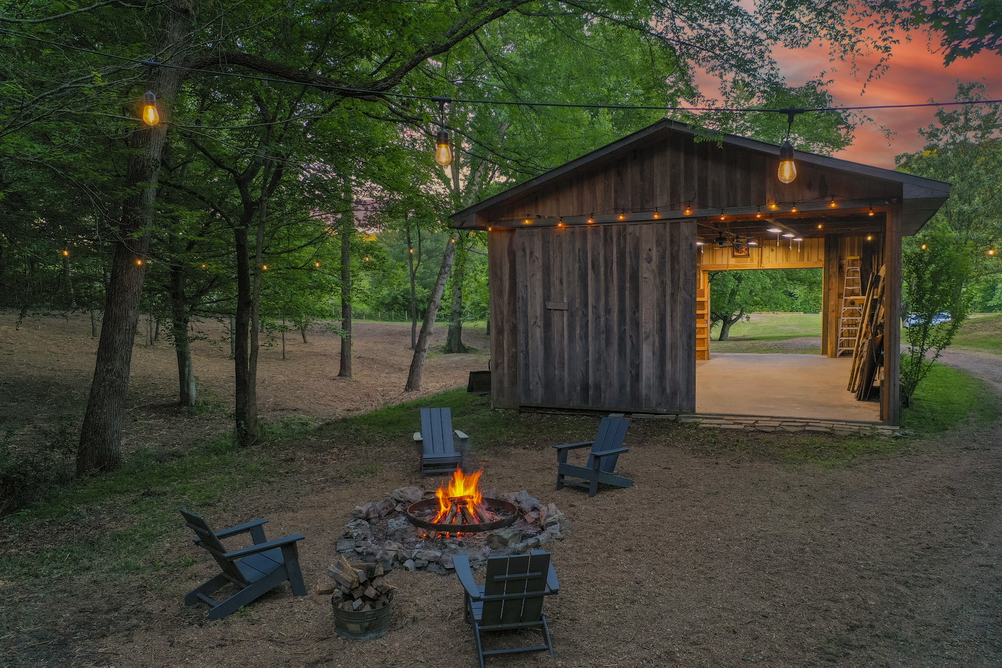 5750 Davis Hollow Road Franklin, TN 37064 - Photo 2 of 41 a view of a backyard with table and chairs under an umbrella with wooden fence