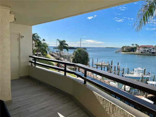 a view of a balcony with chairs and potted plants