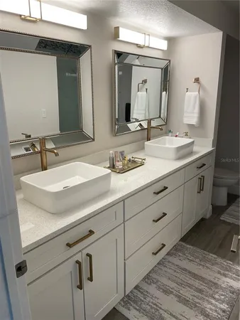 a bathroom with a double vanity sink and a mirror