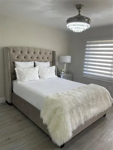 a large bed sitting next to a lamp