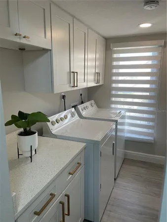 a kitchen with a sink cabinets and wooden floor