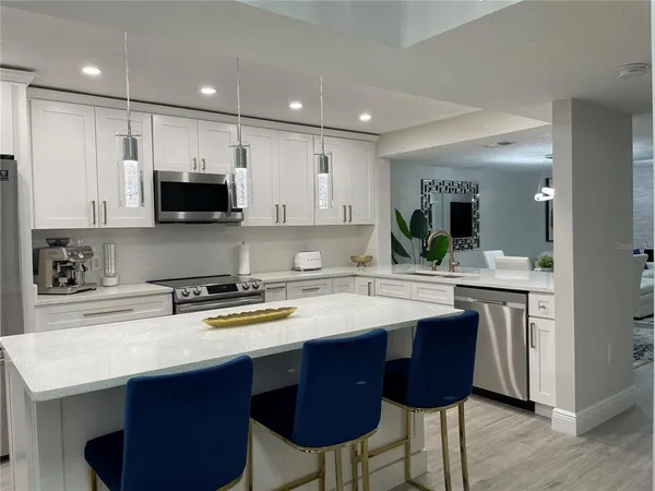 a kitchen with stainless steel appliances stove a sink and a refrigerator