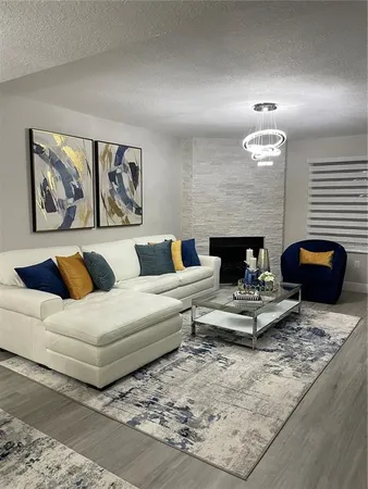 a living room with fireplace and furniture