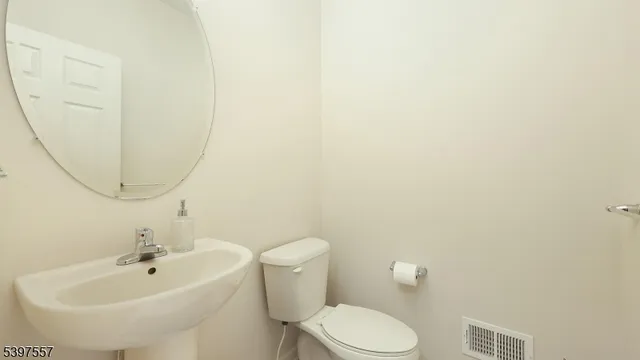 a white toilet sitting next to a white sink