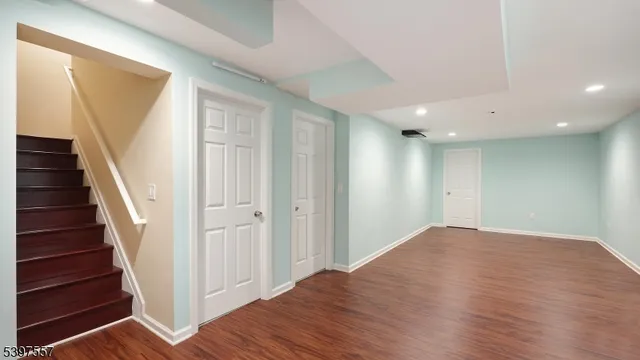 a view of a hallway with wooden floor and entryway