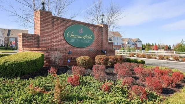 an aerial view of a house with garden space and swimming pool