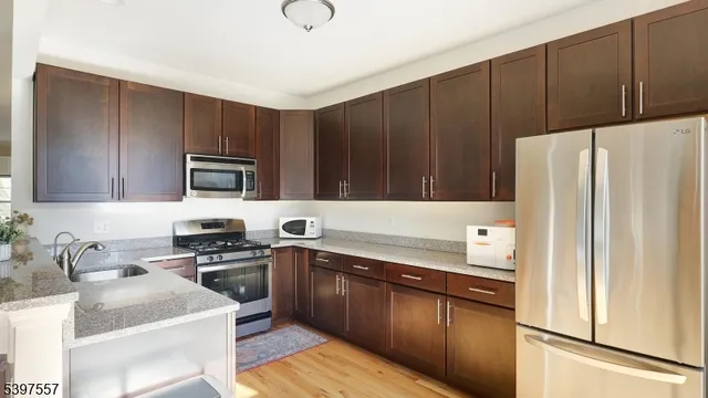 a kitchen with a sink a stove a refrigerator and cabinets