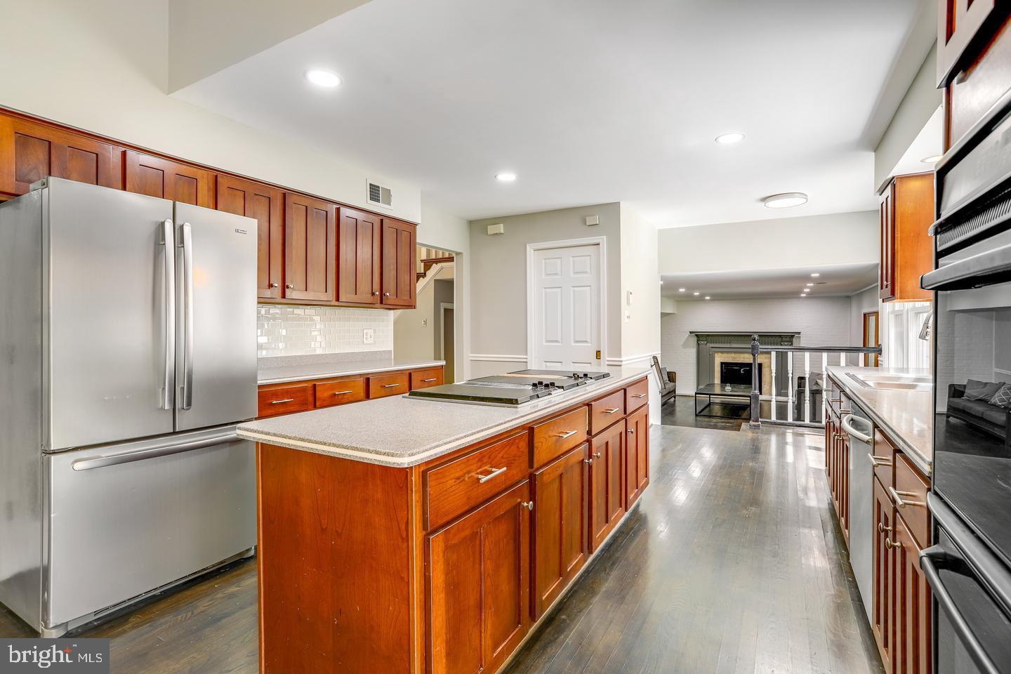 931 Welham Green Road Great Falls, VA 22066 - Photo 12 of 75 a kitchen with stainless steel appliances granite countertop a refrigerator a stove and a sink