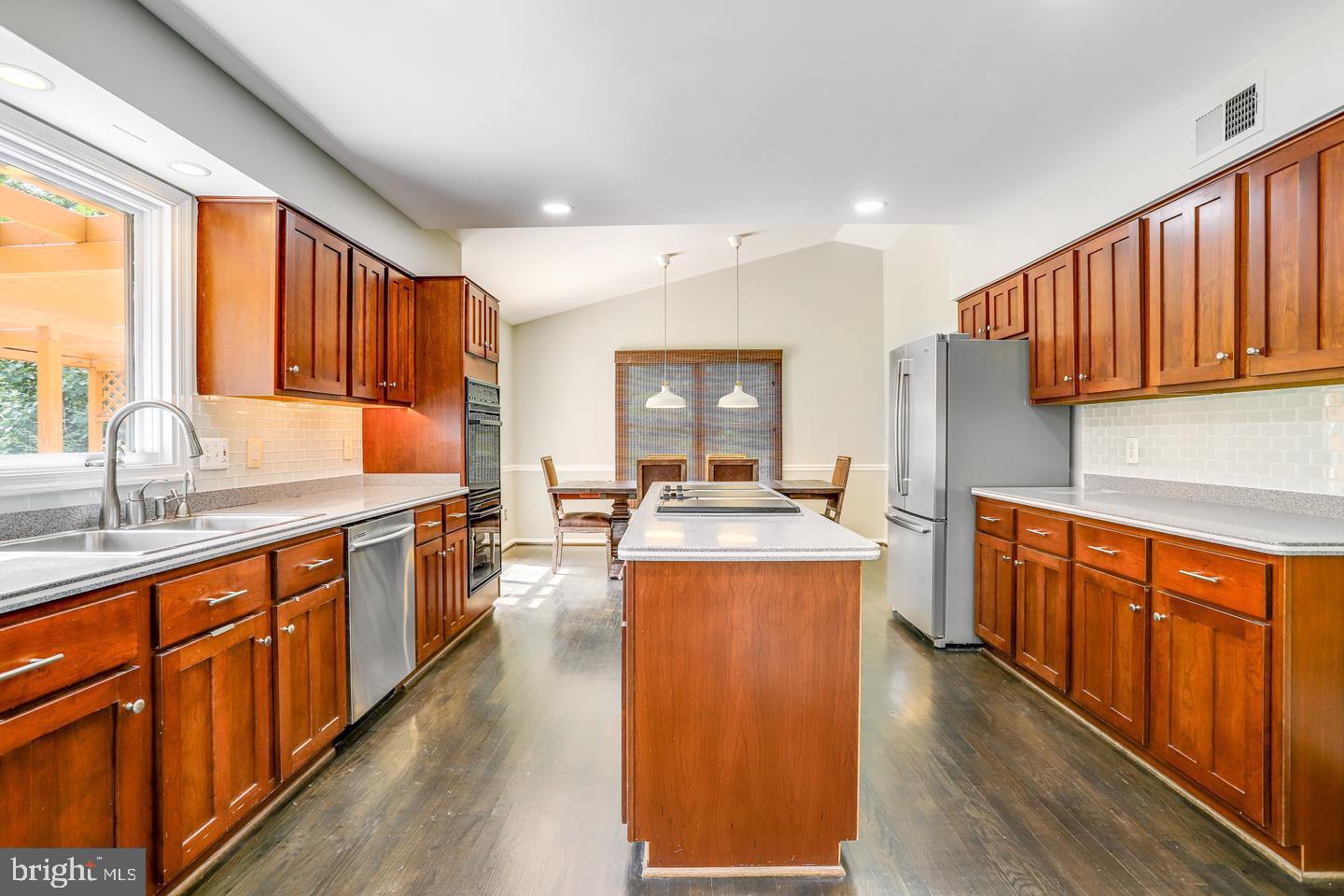 931 Welham Green Road Great Falls, VA 22066 - Photo 15 of 75 a large kitchen with stainless steel appliances granite countertop wooden cabinets a sink and a large window