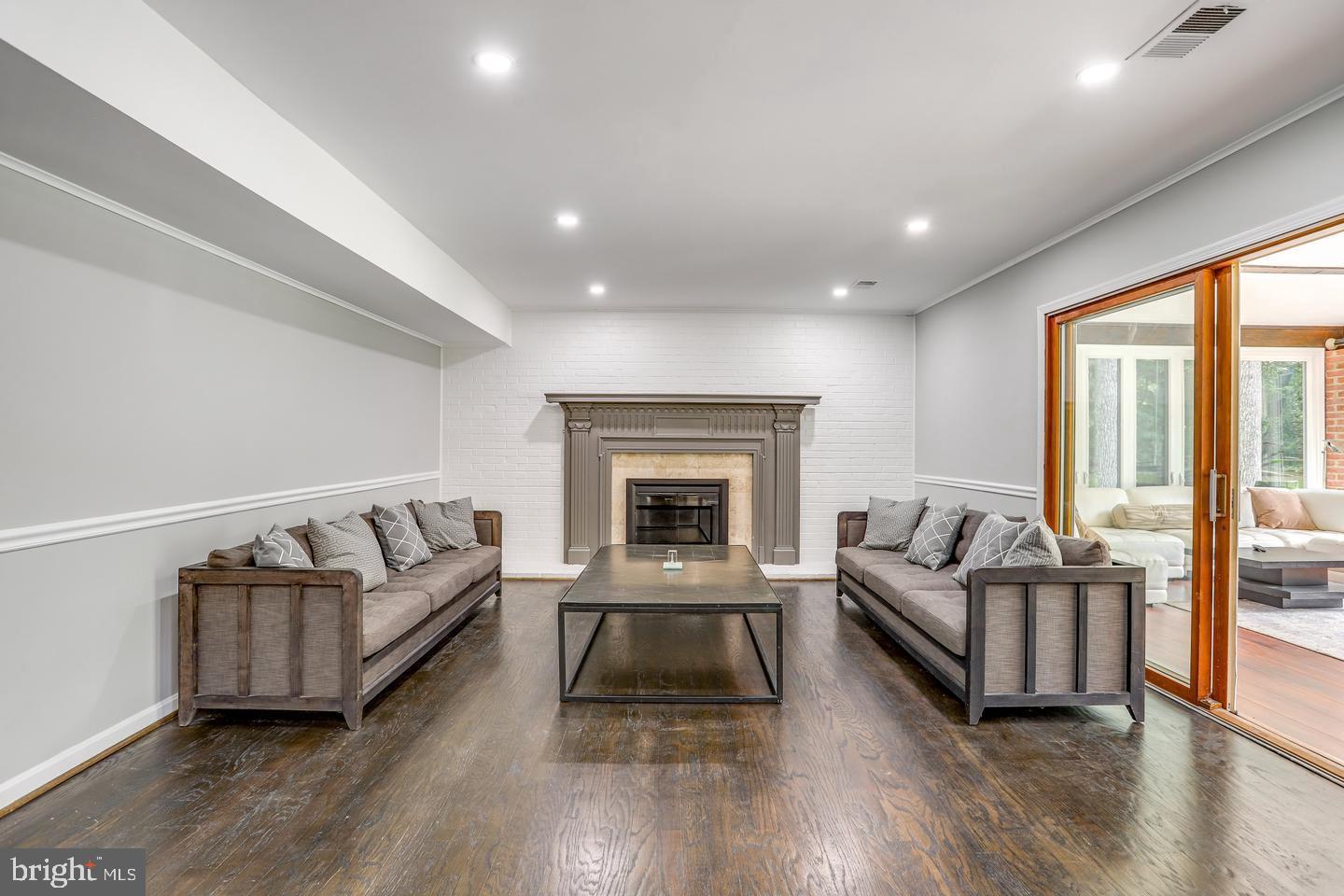 931 Welham Green Road Great Falls, VA 22066 - Photo 23 of 75 a living room with furniture and a fireplace
