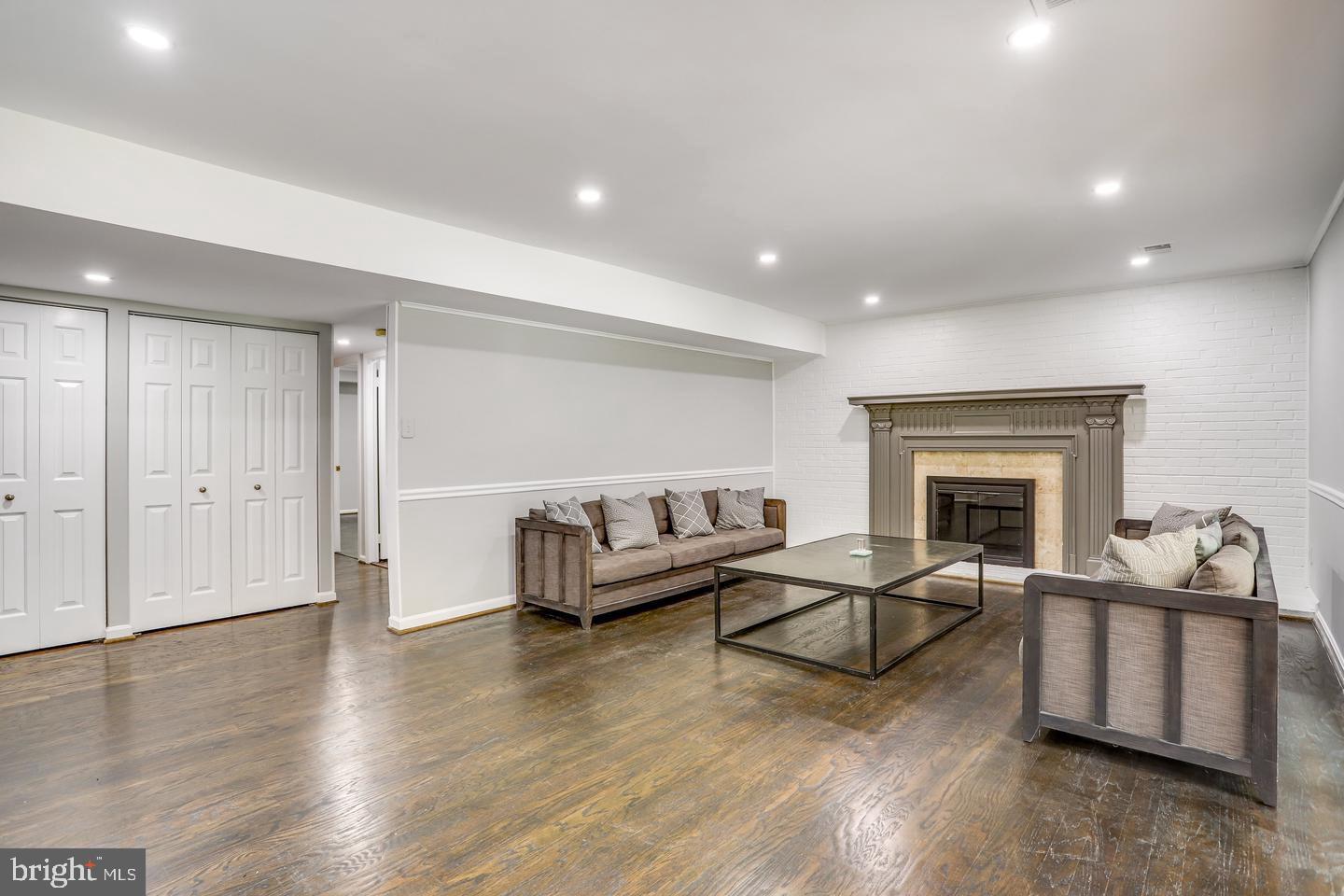931 Welham Green Road Great Falls, VA 22066 - Photo 24 of 75 a living room with furniture and a fireplace