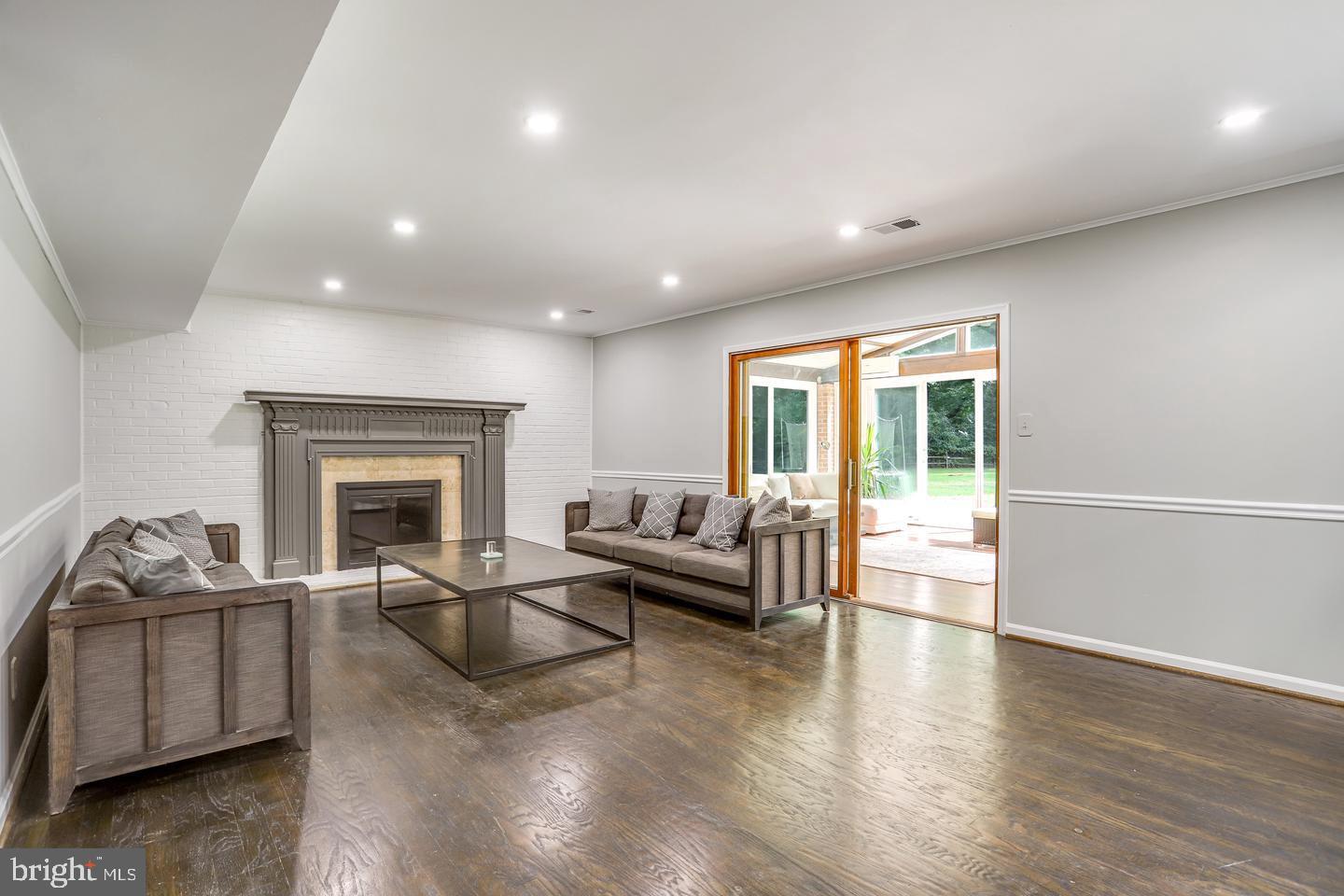 931 Welham Green Road Great Falls, VA 22066 - Photo 25 of 75 a living room with furniture and a fireplace