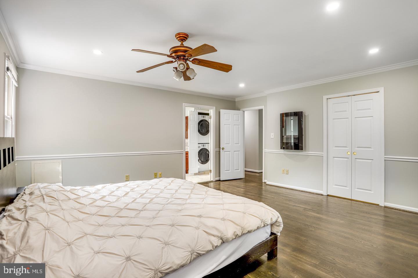 931 Welham Green Road Great Falls, VA 22066 - Photo 37 of 75 a bedroom with a large bed and a chandelier