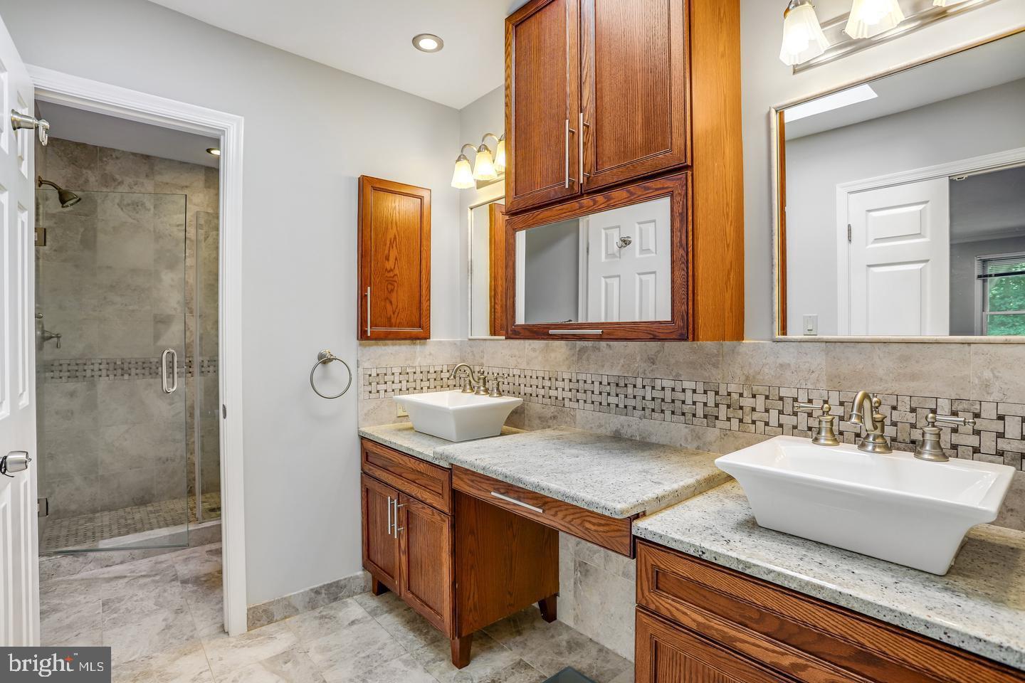 931 Welham Green Road Great Falls, VA 22066 - Photo 43 of 75 a bathroom with a sink and a mirror