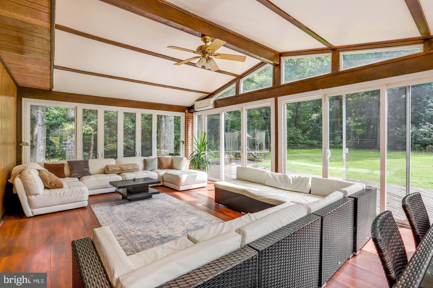 931 Welham Green Road Great Falls, VA 22066 - Photo 56 of 75 a living room with furniture and a floor to ceiling windows