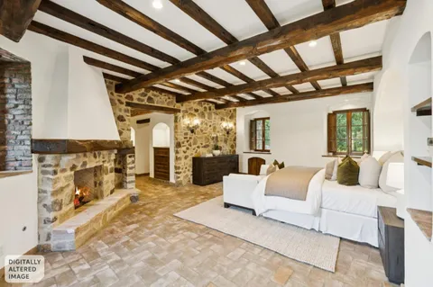 a bedroom with bed and a large window
