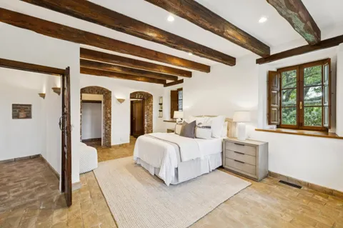 a bed room with bed and window