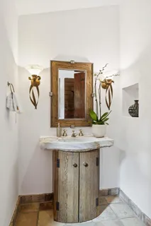 a bedroom with a bed and a large mirror