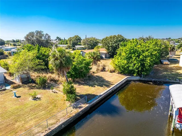 a view of a lake with lawn chairs