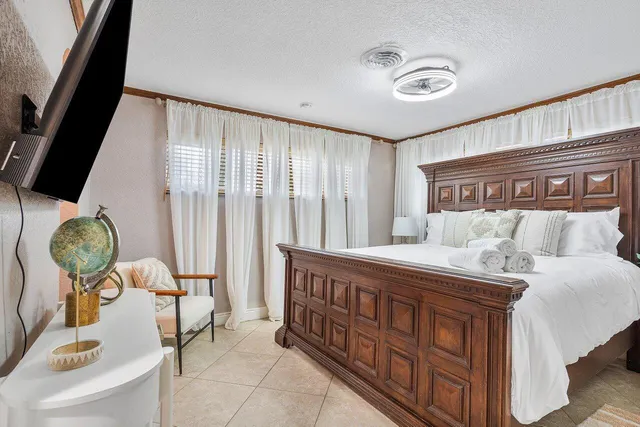 a bedroom with furniture and a large window