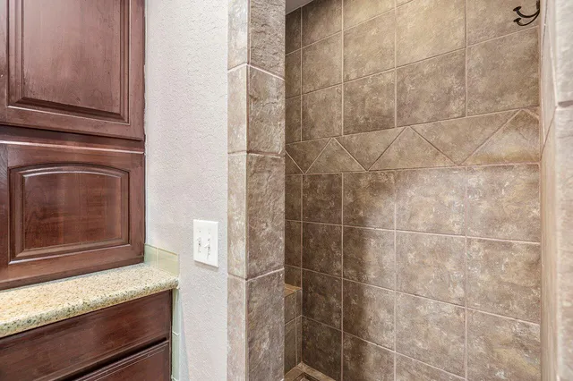 a bathroom with a granite countertop sink and mirror