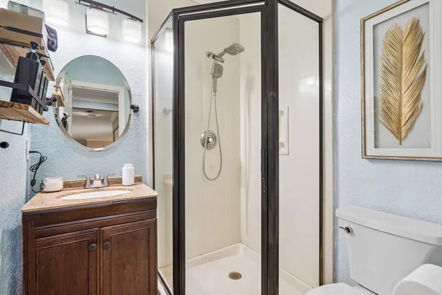 a bathroom with a sink a mirror and a shower