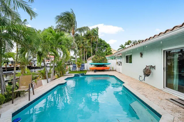 a swimming pool with outdoor seating and yard