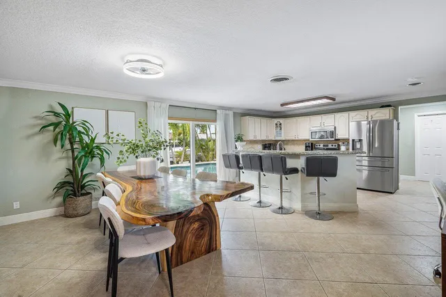 a dining room with furniture and a kitchen view