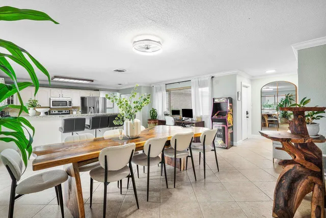 a dining room with furniture and a floor to ceiling window