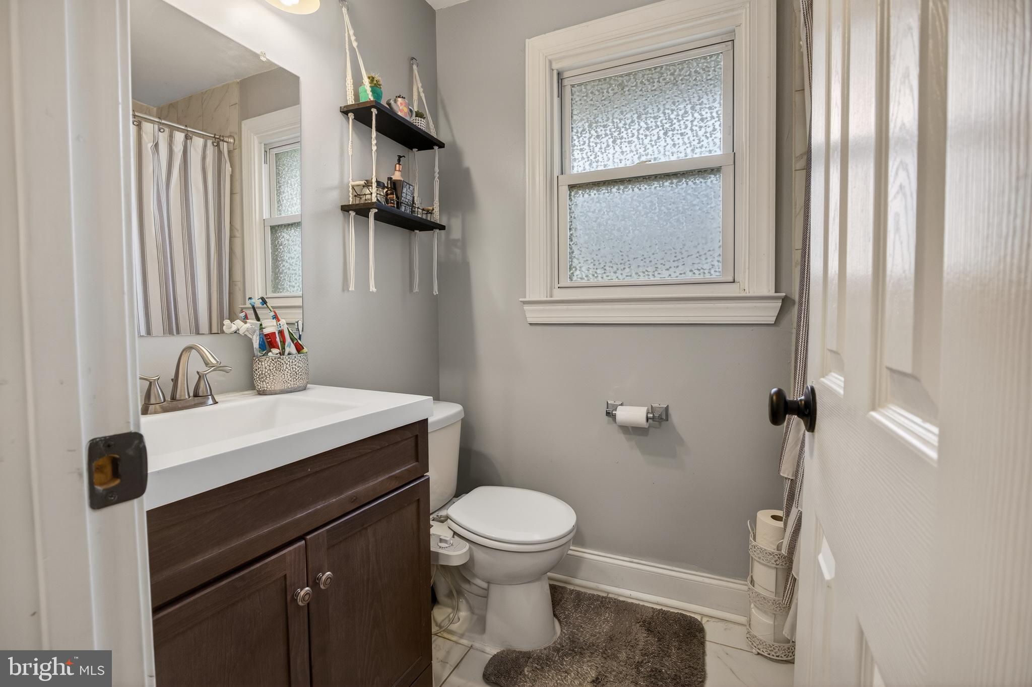 1123 Wynnbrook Road Secane, PA 19018 - Photo 10 of 14 a bathroom with a sink vanity mirror and toilet