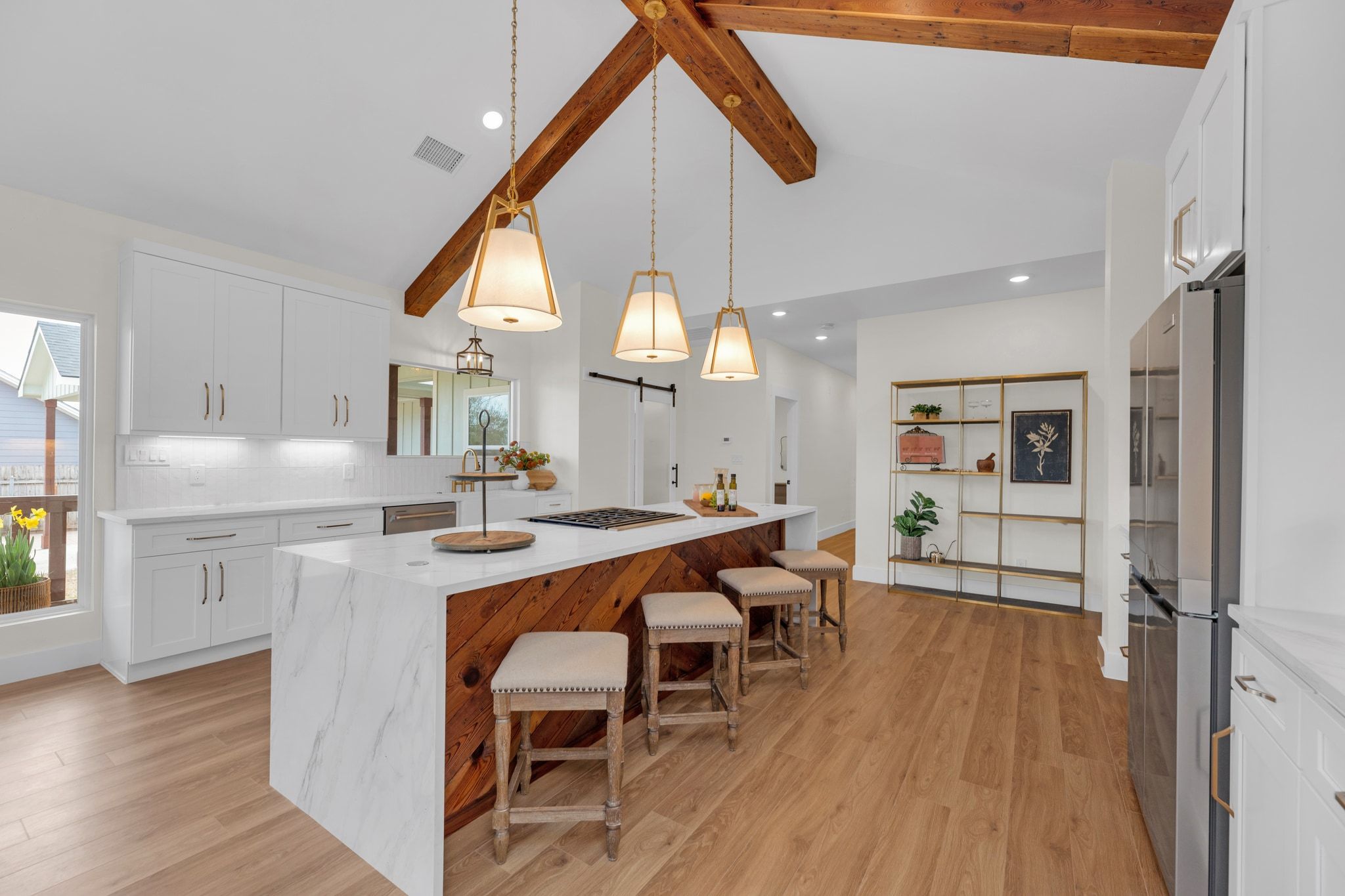 2102 South Church Street Georgetown, TX 78626 - Photo 2 of 40 Appointed with reclaimed cedar beams and chevron detail on kitchen Island, wood from original historic home. Glass barn door on pantry. Whirlpool refrigerator. Calacatta Castana Quartz Countertops.