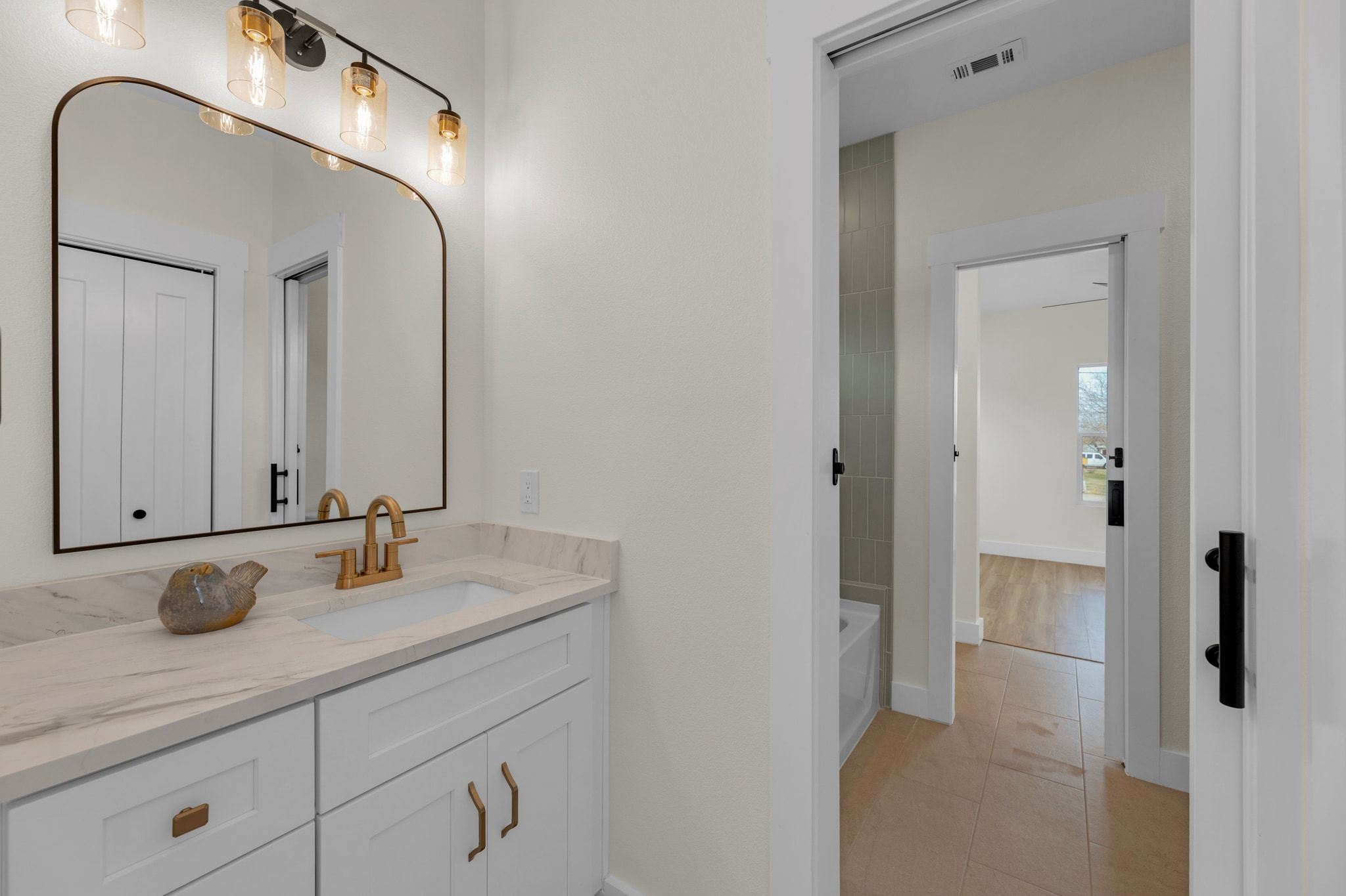2102 South Church Street Georgetown, TX 78626 - Photo 23 of 40 Bathroom featuring vanity, light tile patterned flooring, and a bathtub