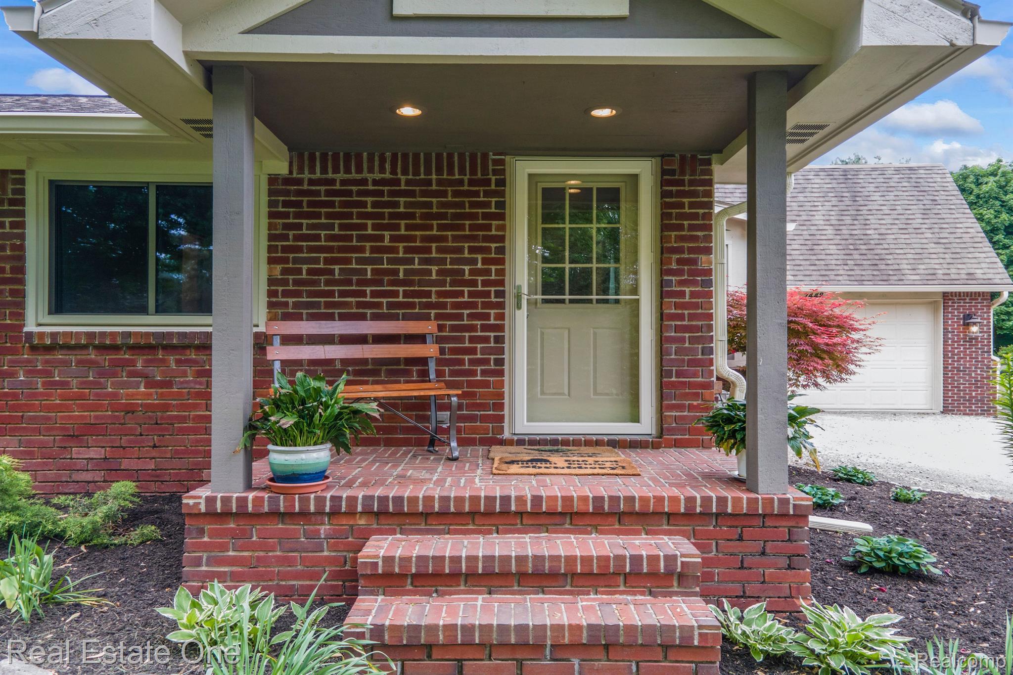 7448 Sharp Road Swartz Creek, MI 48473 - Photo 5 of 49 Full covered brick porch. Let us go in and see.