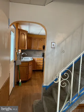 a kitchen with stainless steel appliances granite countertop a sink a stove and cabinets