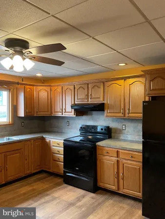 a kitchen with stainless steel appliances granite countertop a sink and cabinets