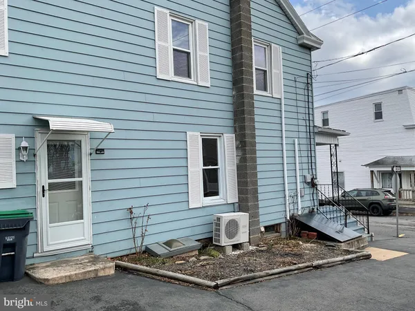 a front view of a house with sitting area