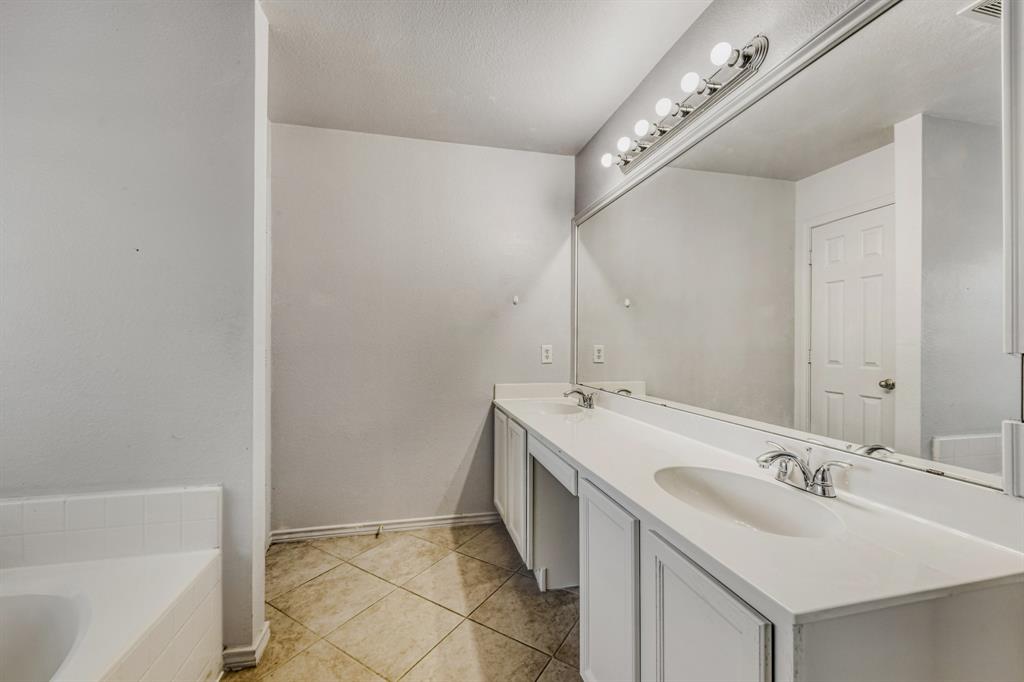 2617 Hereford Road Denton, TX 76210 - Photo 23 of 27 a bathroom with a double vanity sink and mirror