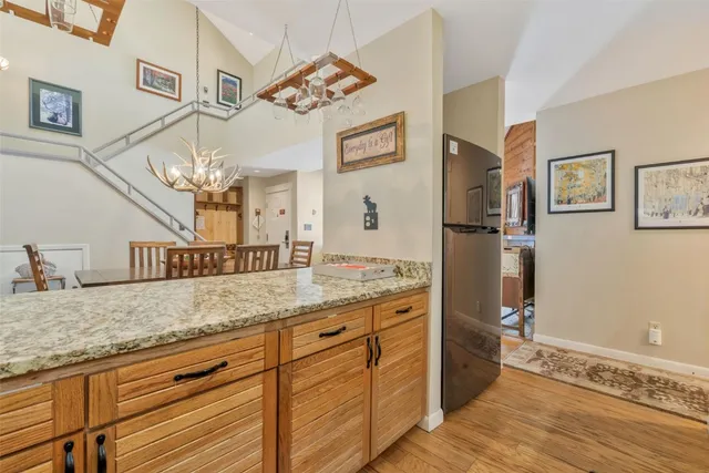 a bathroom with a granite countertop double vanity sink and mirror