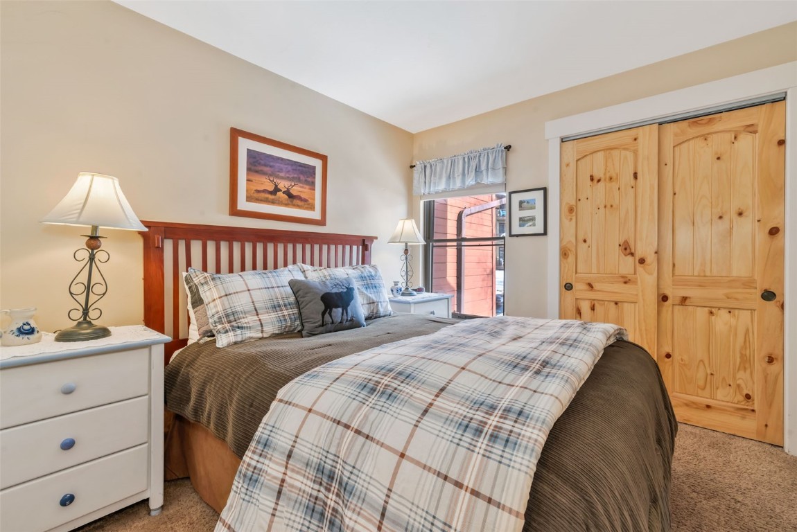 2025 Walton Creek Road, Unit 401 Steamboat Springs, CO 80487 - Photo 19 of 38 a bedroom with a bed and a window