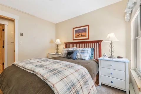 a bedroom with a bed and a night stand