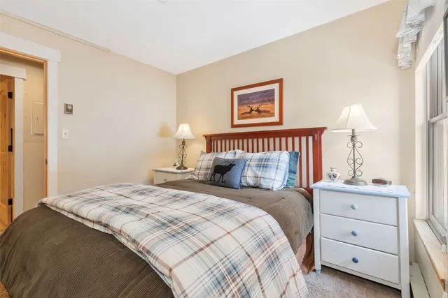 a bedroom with a bed and a night stand