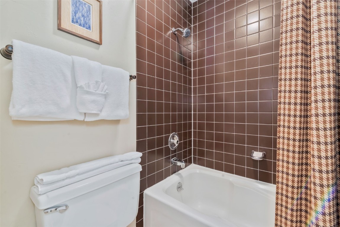 2025 Walton Creek Road, Unit 401 Steamboat Springs, CO 80487 - Photo 22 of 38 a bathroom with a white bath tub and a shower